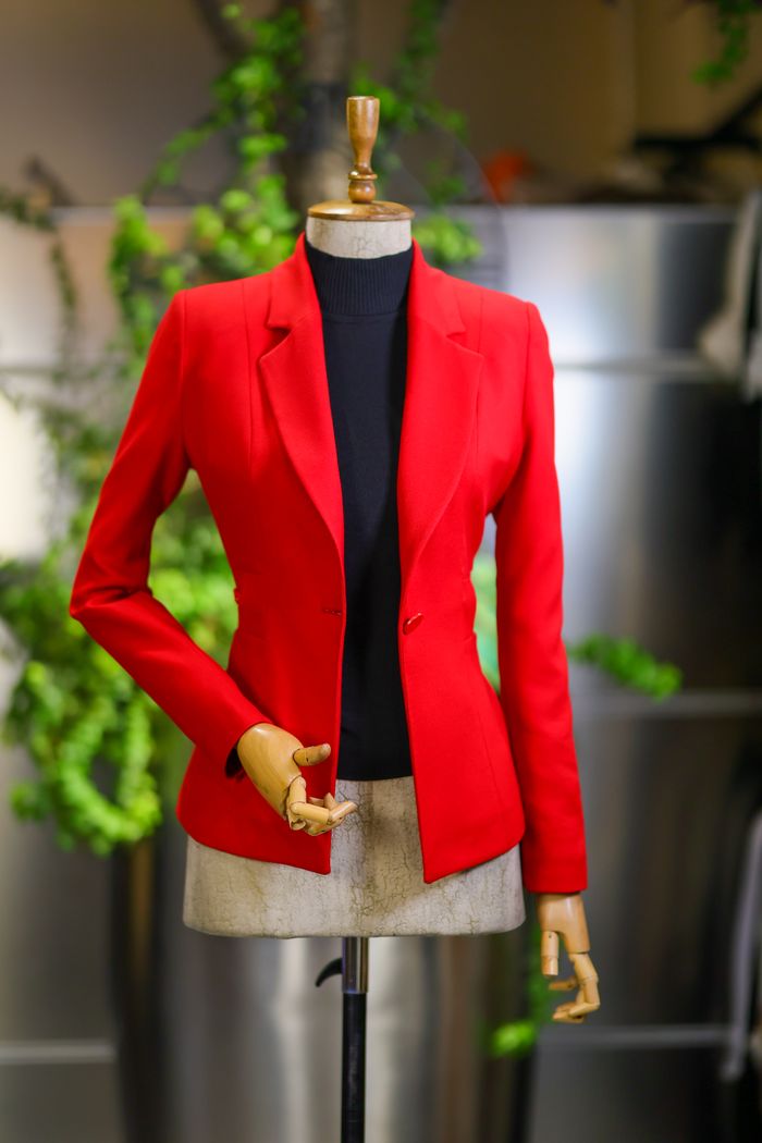 Home Stylish red jacket displayed on a mannequin, perfect for fashion and retail themes.